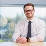 Image of SPA Head of Change and Operational Scrutiny, Scott Ross, sitting at an office desk.